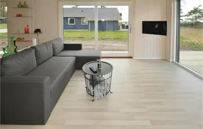 a living room with a couch and a table at Three-Bedroom Holiday Home In Skals in Skals