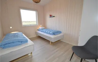 a bedroom with two beds and a window at Three-Bedroom Holiday Home In Skals in Skals