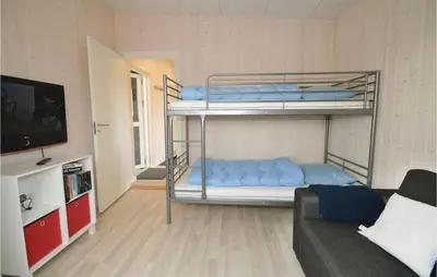 a room with two bunk beds and a couch at Three-Bedroom Holiday Home In Skals in Skals
