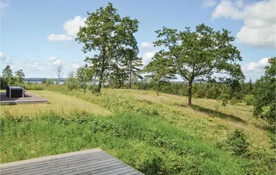 a view of a field with trees in the distance at Three-Bedroom Holiday Home In Skals in Skals