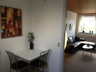 a living room with a table and a couch at Thy Ferielejlighed in Thisted