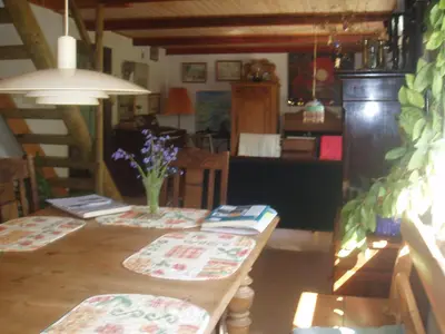 a dining room with a table with flowers on it at Country house in Karby