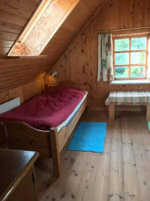 a bedroom with a bed in a wooden cabin at Country house in Karby