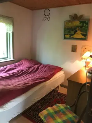 a bedroom with a bed and a desk and a window at Country house in Karby