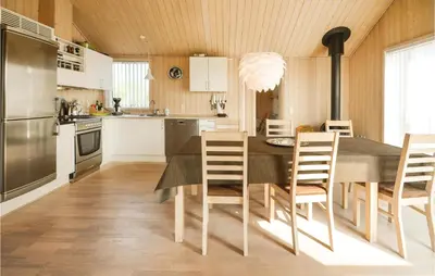 a kitchen with a dining room table and chairs at Three-Bedroom Holiday Home In Fjerritslev in Fjerritslev