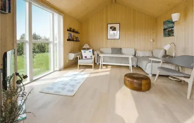 a living room with a couch and a table at Three-Bedroom Holiday Home In Fjerritslev in Fjerritslev