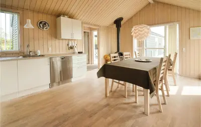 a kitchen and dining room with a table and chairs at Three-Bedroom Holiday Home In Fjerritslev in Fjerritslev