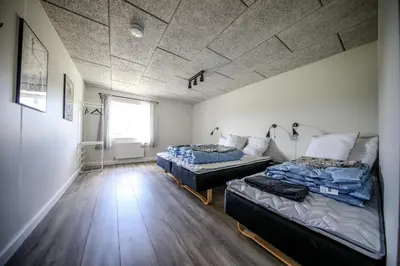 a room with two beds and a window at Bed and Breakfast Lemvig in Lemvig