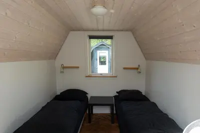 a small room with two beds and a table at Bed and Breakfast Lemvig in Lemvig