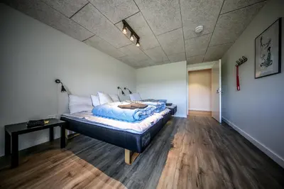 a bedroom with a bed and a table in it at Bed and Breakfast Lemvig in Lemvig