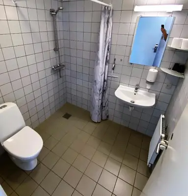 a bathroom with a toilet and a sink at Motel Skive in Skive
