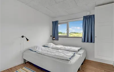 two beds in a room with a window at Three-Bedroom Holiday Home In Spottrup in Spottrup
