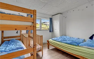 a bedroom with two bunk beds and a window at Three-Bedroom Holiday Home In Spottrup in Spottrup