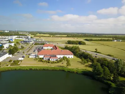 an aerial view of a house next to a lake at Hotel Søparken in Åbybro