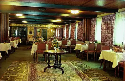 a dining room with tables and chairs and a table at St. Binderup Kro in Store Binderup