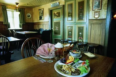 a wooden table with a plate of food on it at St. Binderup Kro in Store Binderup