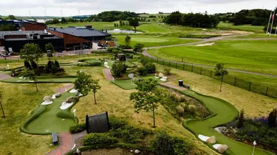 an overhead view of a golf course at HimmerLand in Gatten