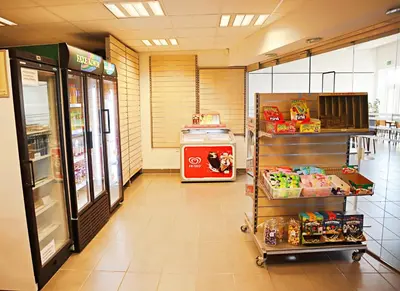 a grocery store aisle with a food cart in a store at Plexus Hytterne in Holstebro