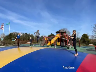 a group of children playing on a playground at Myrhoj Camping in Myrhøj