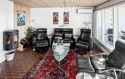 a living room with leather furniture and a fireplace at Two-Bedroom Holiday Home In Pandrup in Pandrup
