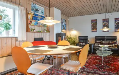 a dining room with a table and chairs at Two-Bedroom Holiday Home In Pandrup in Pandrup