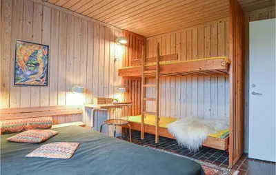 a bedroom with two bunk beds in a room at Two-Bedroom Holiday Home In Pandrup in Pandrup