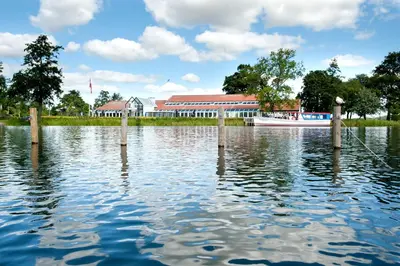 a large body of water with a building and a boat at Golf Hotel Viborg in Viborg