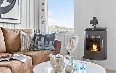 a living room with a couch and a fireplace at Two-Bedroom Holiday Home In Pandrup in Pandrup