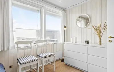 a white room with a mirror and two chairs and a window at Two-Bedroom Holiday Home In Pandrup in Pandrup