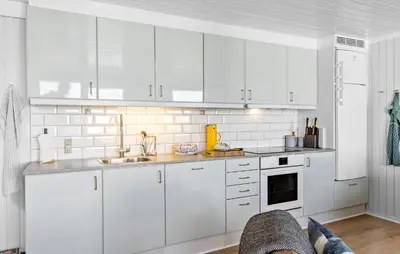 a white kitchen with white cabinets and a sink at Two-Bedroom Holiday Home In Pandrup in Pandrup