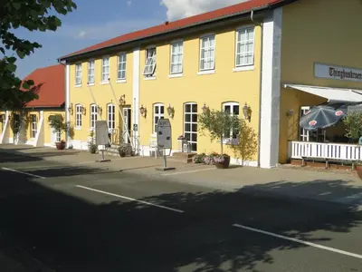 a yellow building on the side of a street at Thinghuskroen in Vestervig