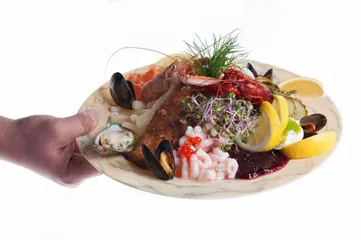 a plate of food with seafood and vegetables on it at Thinghuskroen in Vestervig