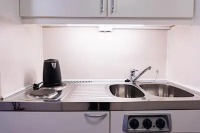 a kitchen with a sink and a counter top at Palads Hotel in Viborg