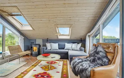 a dog sitting in a chair in a living room at Two-Bedroom Holiday Home In Lemvig in Lemvig