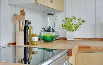 a kitchen counter with bottles and a bowl of lemons at Two-Bedroom Holiday Home In Lemvig in Lemvig