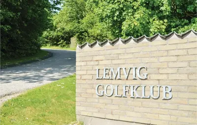a brick wall with a sign that reads leving collective at Two-Bedroom Holiday Home In Lemvig in Lemvig