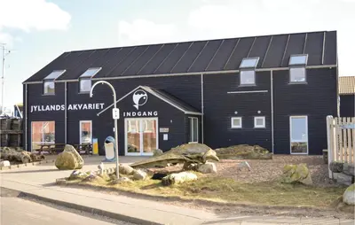 a large black building with a sign on it at Two-Bedroom Holiday Home In Lemvig in Lemvig