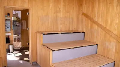 a staircase in a room with wooden walls at Hotel Strandtangen in Skive