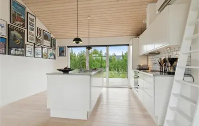 a kitchen with white cabinets and a large window at Three-Bedroom Holiday Home In Fjerritslev in Fjerritslev