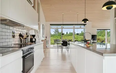 a kitchen with white countertops and a dining room at Three-Bedroom Holiday Home In Fjerritslev in Fjerritslev