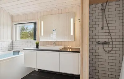 a bathroom with a sink and a bath tub at Three-Bedroom Holiday Home In Fjerritslev in Fjerritslev