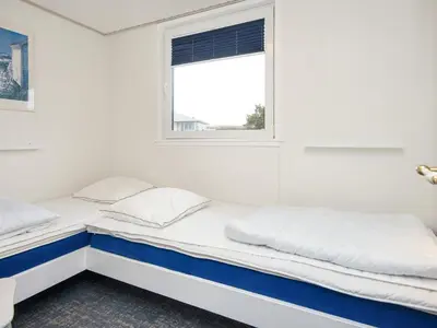 two beds in a white room with a window at 5 person holiday home in Lemvig-By Traum in Trans