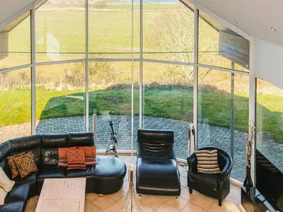a living room with a couch and chairs in front of a large window at Luxury Fjordview Retreat-By Traum in Højslev