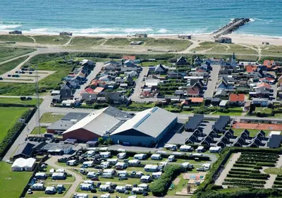 an aerial view of a parking lot next to the ocean at Thyborøn Cottages in Thyborøn