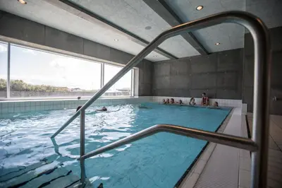 a large swimming pool with people in it at Thyborøn Cottages in Thyborøn