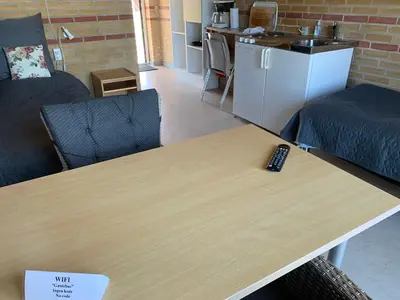 a remote control sitting on top of a wooden table at Danhostel Fjaltring in Fjaltring