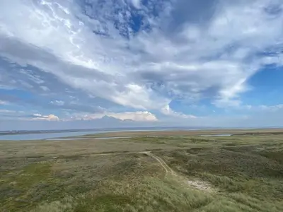 an open field with a cloudy sky and water at 5 person holiday home in Vestervig-By Traum in Vestervig