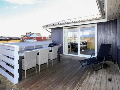 a deck with chairs and a table on a house at Luxury Spa Retreat near Sea - By Traum Ferienwohnungen in Ferring