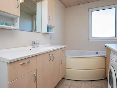 a bathroom with a sink and a bath tub at Luxury Spa Retreat near Sea - By Traum Ferienwohnungen in Ferring