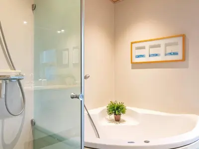a bathroom with a shower and a sink at Modern Retreat with Spa - By Traum Ferienwohnungen in Løkken